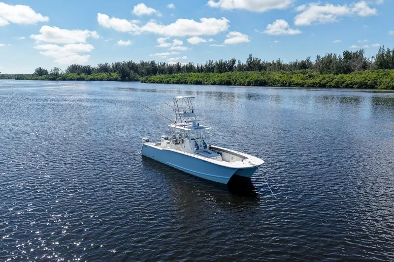  Yacht Photos Pics 2020 Tideline 365 Offshore boat on calm water under a clear blue sky.