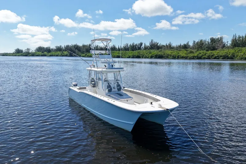  Yacht Photos Pics 2020 Tideline 365 Offshore boat on calm water under blue sky.