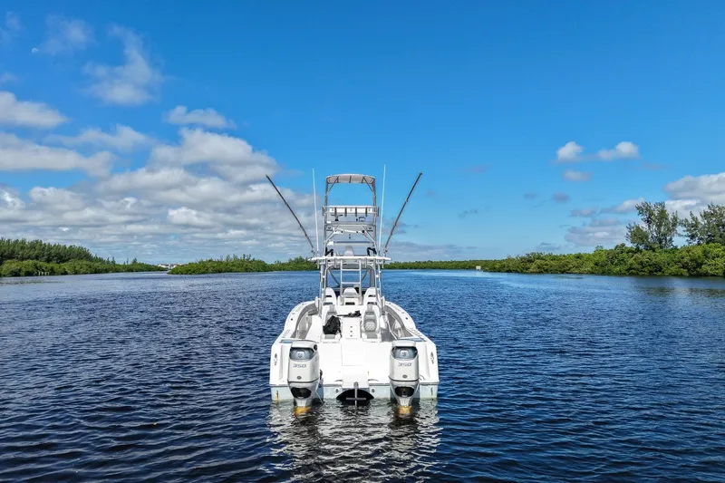  Yacht Photos Pics 2020 Tideline 365 Offshore boat on calm water under clear blue sky.