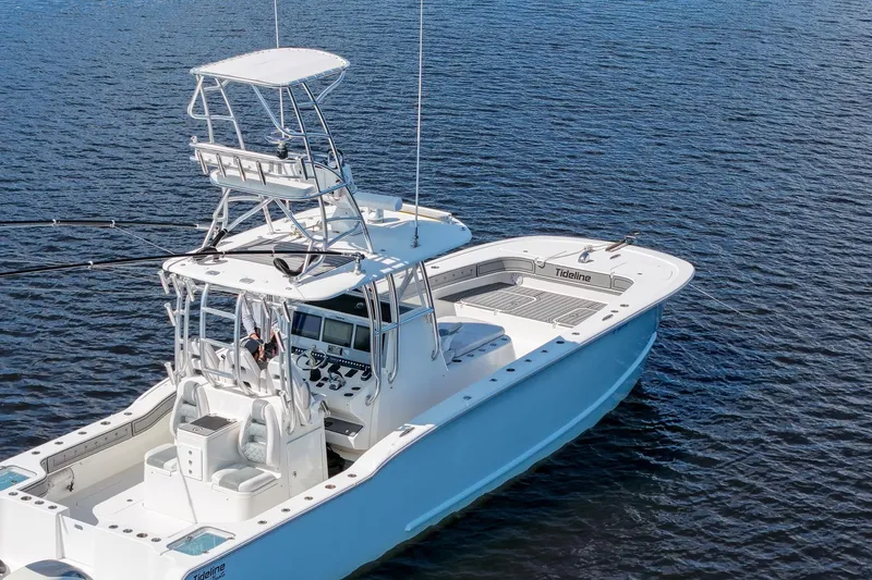  Yacht Photos Pics 2020 Tideline 365 Offshore boat on calm water, featuring a sleek design and spacious deck.
