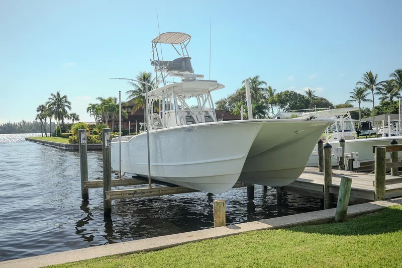  Yacht Photos Pics 2020 Tideline 365 Offshore boat docked near palm trees and waterfront homes.