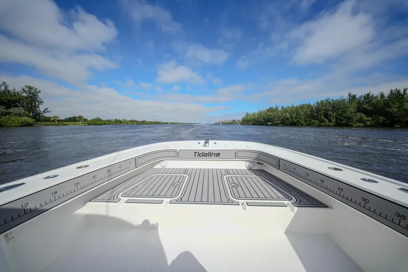 Yacht Photos Pics 2020 Tideline 365 Offshore boat on a scenic river under a blue sky.