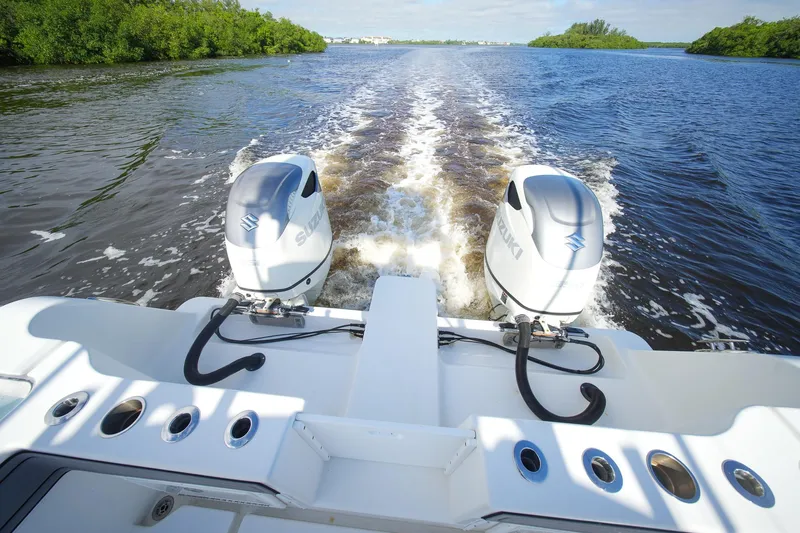 Yacht Photos Pics 2020 Tideline 365 Offshore boat with dual Suzuki outboard motors cruising on a river.