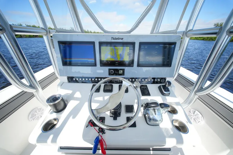  Yacht Photos Pics 2020 Tideline 365 Offshore boat dashboard with navigation screens and controls on open water.