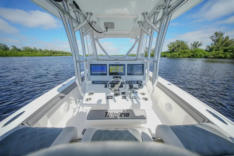  Yacht Photos Pics 2020 Tideline 365 Offshore boat cockpit with advanced navigation systems on a serene waterway.