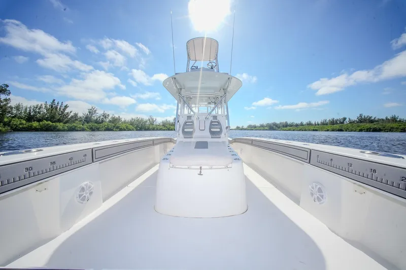  Yacht Photos Pics 2020 Tideline 365 Offshore boat on a sunny day, surrounded by water and trees.