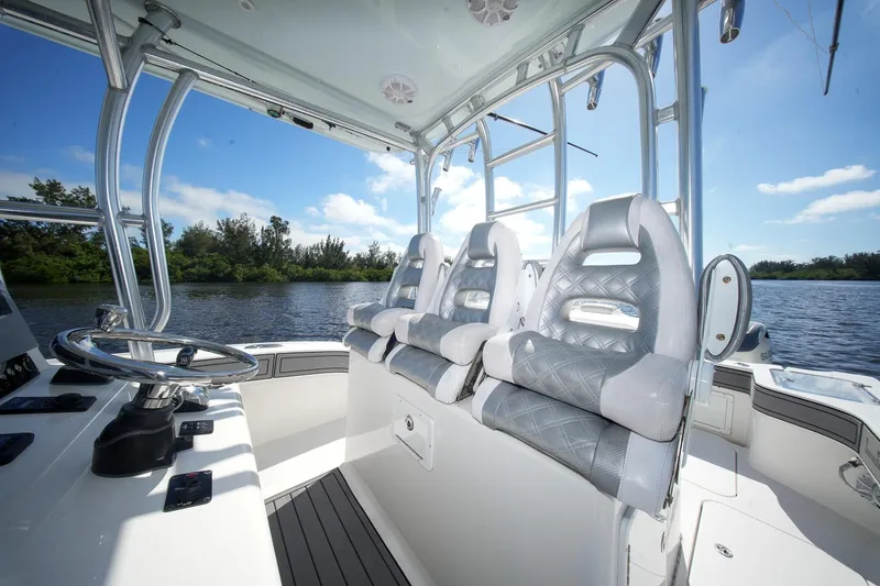  Yacht Photos Pics Interior of 2020 Tideline 365 Offshore boat with luxurious seating and steering wheel.