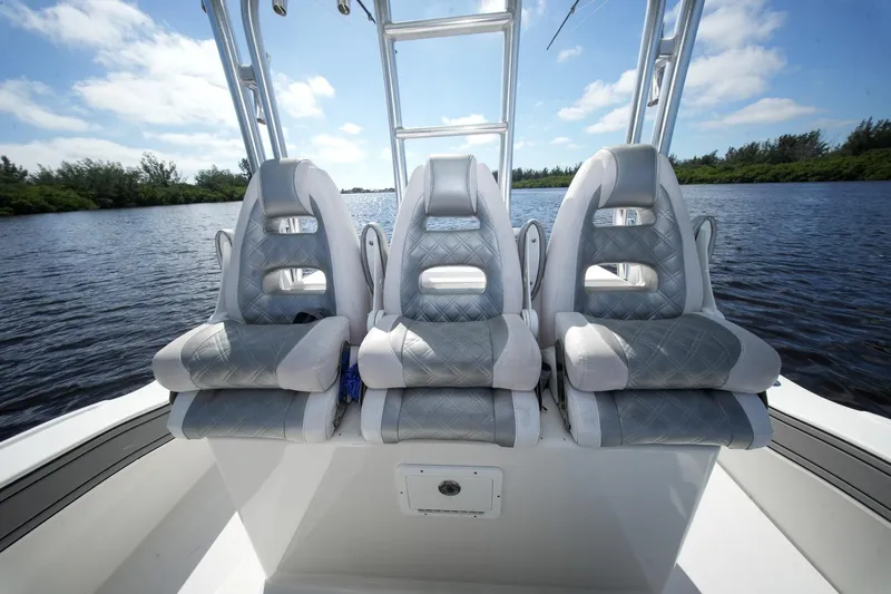  Yacht Photos Pics Three luxury seats on a 2020 Tideline 365 Offshore boat, with a scenic water backdrop.