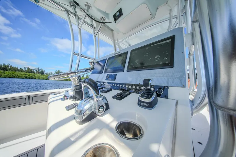  Yacht Photos Pics Control panel of 2020 Tideline 365 Offshore boat with navigation screens and steering wheel.