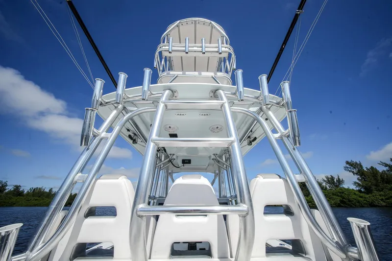  Yacht Photos Pics 2020 Tideline 365 Offshore boat with tower against blue sky backdrop.