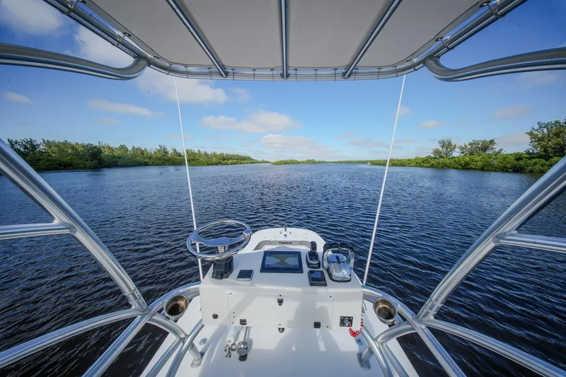  Yacht Photos Pics View from Tideline 365 Offshore boat, 2020 model, navigating a serene river under a clear sky.