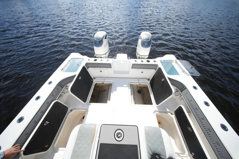  Yacht Photos Pics 2020 Tideline 365 Offshore boat with open storage compartments on calm water.