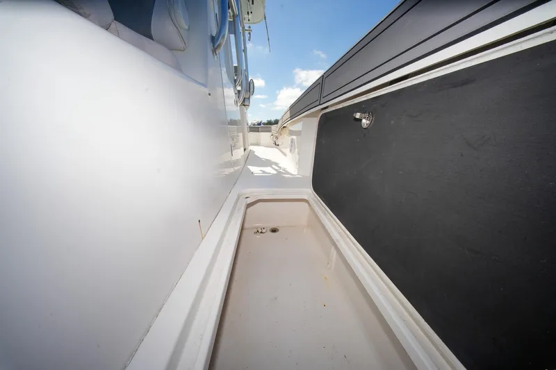  Yacht Photos Pics 2020 Tideline 365 Offshore boat deck with storage compartment, clear sky background.
