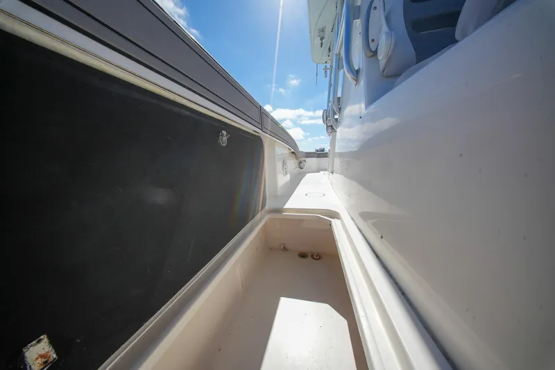  Yacht Photos Pics 2020 Tideline 365 Offshore boat deck with storage compartment under clear blue sky.