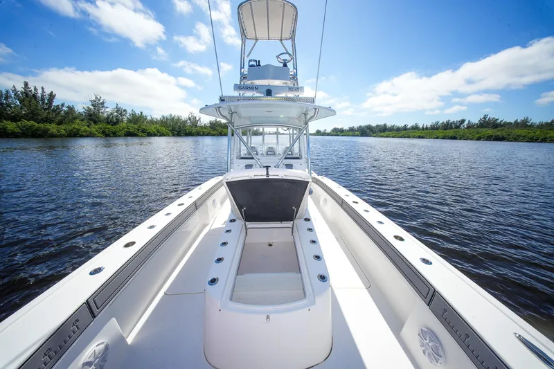  Yacht Photos Pics 2020 Tideline 365 Offshore boat on calm water under a clear blue sky.