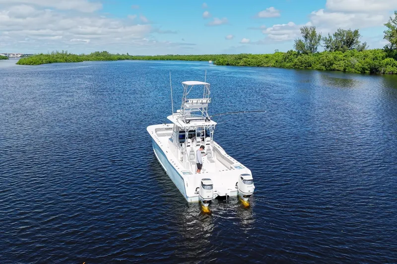  Yacht Photos Pics Aerial view of 2020 Tideline 365 Offshore boat cruising on a serene waterway.