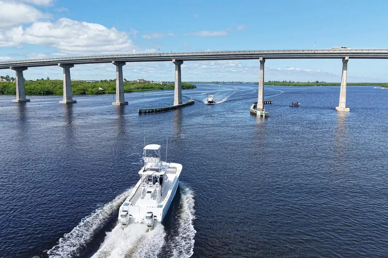  Yacht Photos Pics A 2020 Tideline 365 Offshore boat cruising under a bridge on a sunny day.