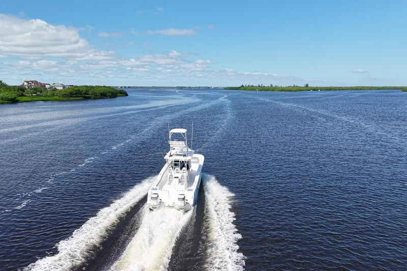  Yacht Photos Pics Aerial view of 2020 Tideline 365 Offshore boat cruising on a wide river.