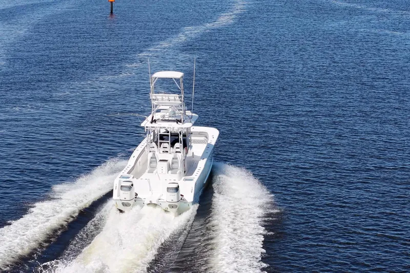  Yacht Photos Pics 2020 Tideline 365 Offshore boat cruising on open water, rear view.
