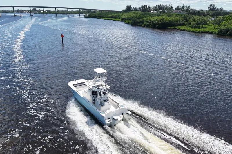  Yacht Photos Pics Aerial view of 2020 Tideline 365 Offshore boat cruising on a scenic river.