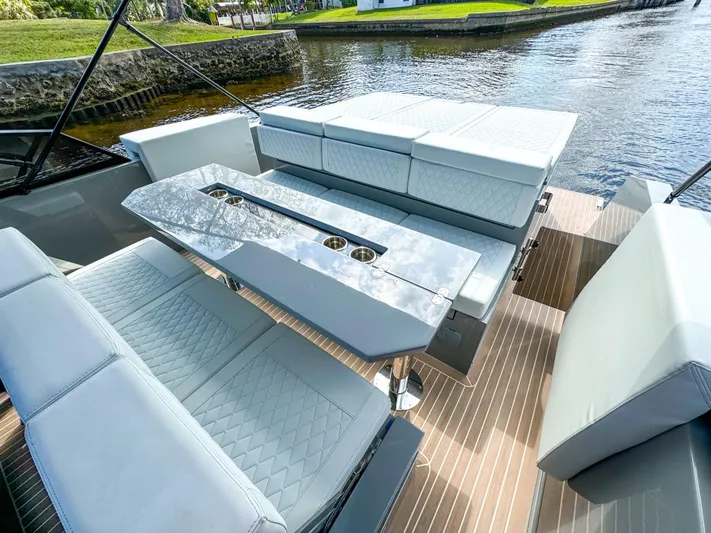  Yacht Photos Pics 2024 De Antonio Yachts D28 Cruiser interior with sleek seating and modern design on a serene waterway.