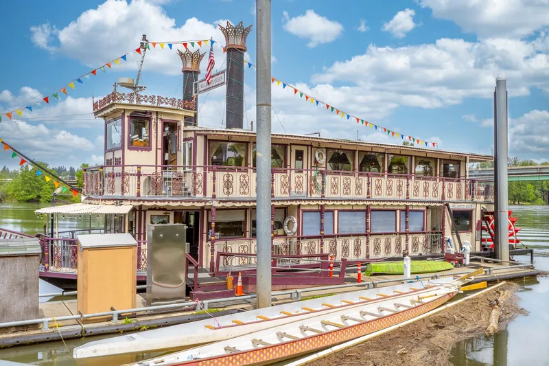 Willamette Queen Yacht Photos Pics Vintage 1990 Custom Howdy Eidelman Sternwheeler docked, adorned with colorful flags under a blue sky.