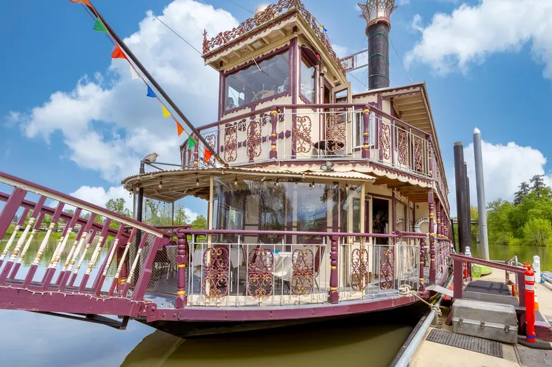 Willamette Queen Yacht Photos Pics Vintage 1990 Howdy Eidelman Sternwheeler boat docked, featuring ornate design and colorful flags.