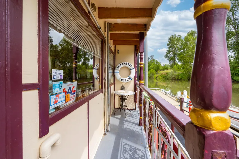 Willamette Queen Yacht Photos Pics Exterior view of 1990 Custom Howdy Eidelman Sternwheeler, featuring deck and river scenery.