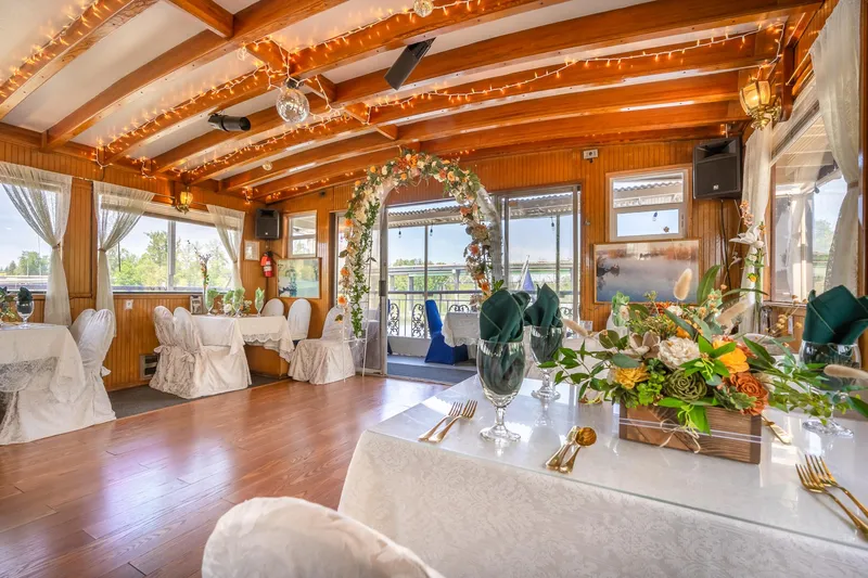 Willamette Queen Yacht Photos Pics Elegant interior of 1990 Howdy Eidelman Sternwheeler, decorated for an event with floral arrangements.