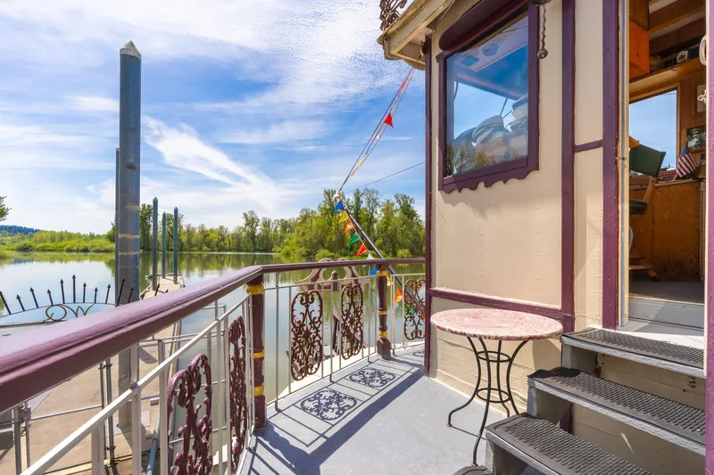 Willamette Queen Yacht Photos Pics Sunny deck of 1990 Howdy Eidelman Sternwheeler with ornate railing and river view.