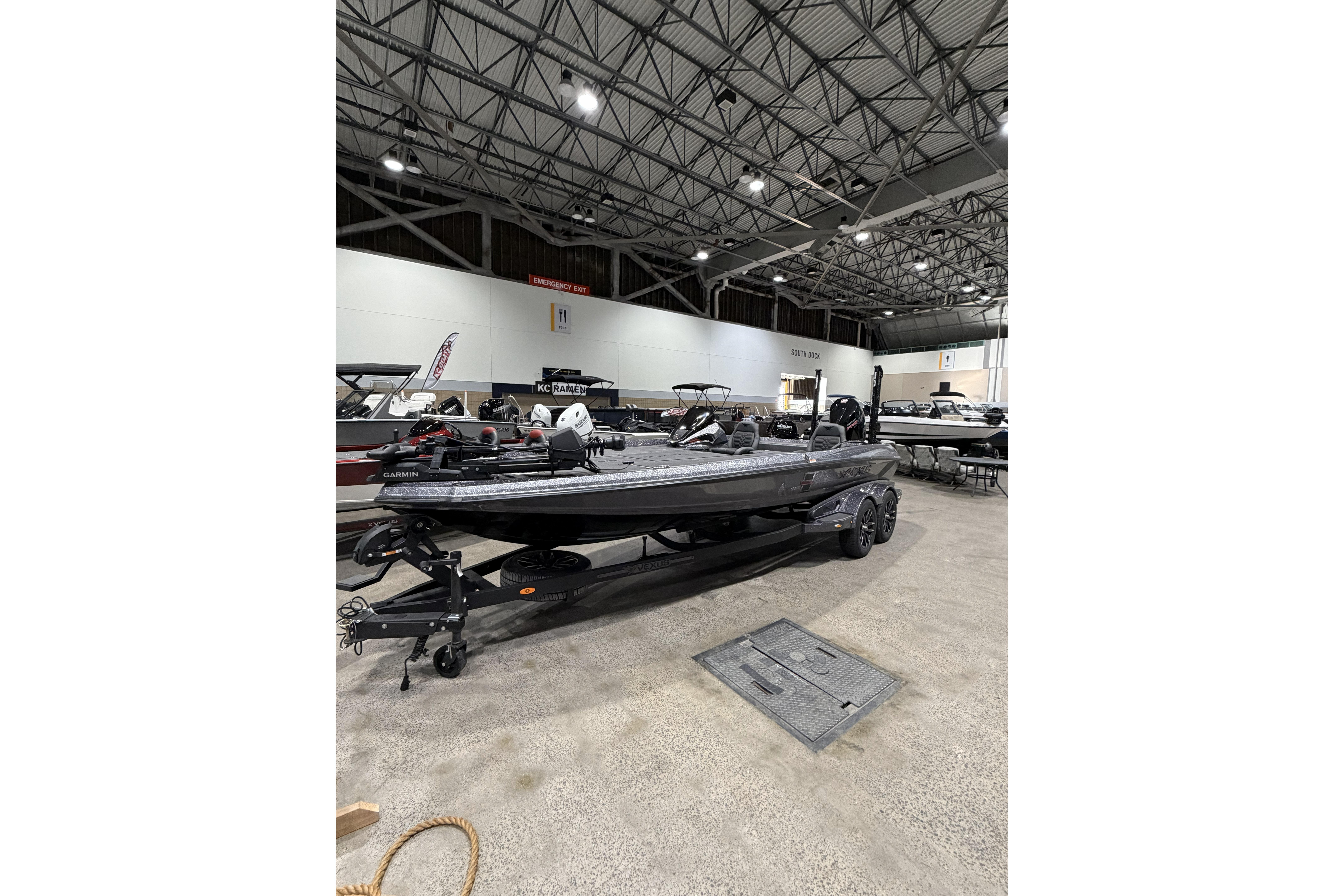 2026 Vexus boat displayed indoors, featuring sleek design and advanced equipment.
