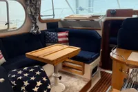 Interior of 2001 Nimbus 345 Coupe with cozy seating and nautical decor.