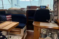 Interior of 2001 Nimbus 345 Coupe boat with wooden furnishings and nautical decor.