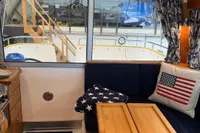 Interior of 2001 Nimbus 345 Coupe with American-themed cushions and wooden accents.