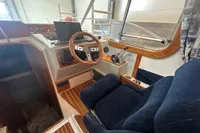 Interior of a 2001 Nimbus 345 Coupe boat with steering wheel and controls.