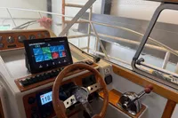 Steering console of 2001 Nimbus 345 Coupe with navigation display and wooden accents.