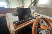 Control panel of a 2001 Nimbus 345 Coupe with wooden steering wheel and navigation display.