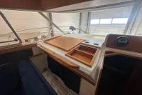 Interior view of a 2001 Nimbus 345 Coupe boat, featuring wooden dashboard and seating.