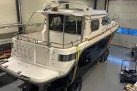 2001 Nimbus 345 Coupe boat in a garage, viewed from the rear, showcasing its sleek design.