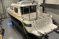 2001 Nimbus 345 Coupe boat in indoor storage, rear view.