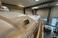 Nimbus 345 Coupe 2001 in a garage, showcasing sleek design and wooden deck details.