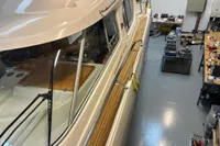 Nimbus 345 Coupe 2001 in workshop, showcasing sleek design and wooden deck details.