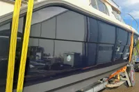 Nimbus 345 Coupe 2001 boat on trailer, reflecting surroundings, secured with yellow straps.