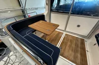 Nimbus 345 Coupe 2001 interior with wooden table and navy seating.