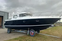 Nimbus 345 Coupe 2001 boat on trailer, overcast sky background.