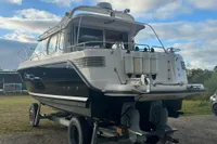 2001 Nimbus 345 Coupe boat on trailer under cloudy sky.