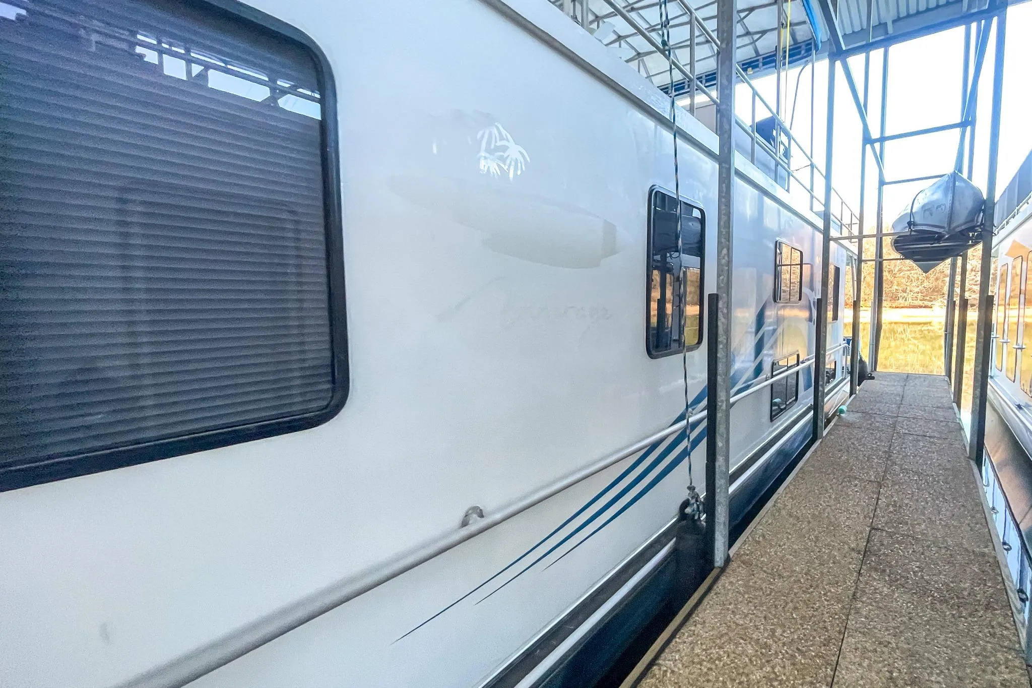 1996 Lakeview 66 x 16 Widebody Houseboat docked in a marina.