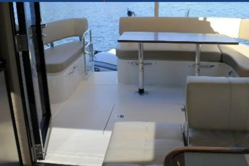  Yacht Photos Pics Interior view of 2017 Carver C37 yacht with seating and table, overlooking water.