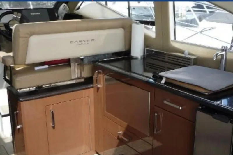  Yacht Photos Pics Interior of 2017 Carver C37 yacht featuring a modern kitchen area with wood cabinetry.