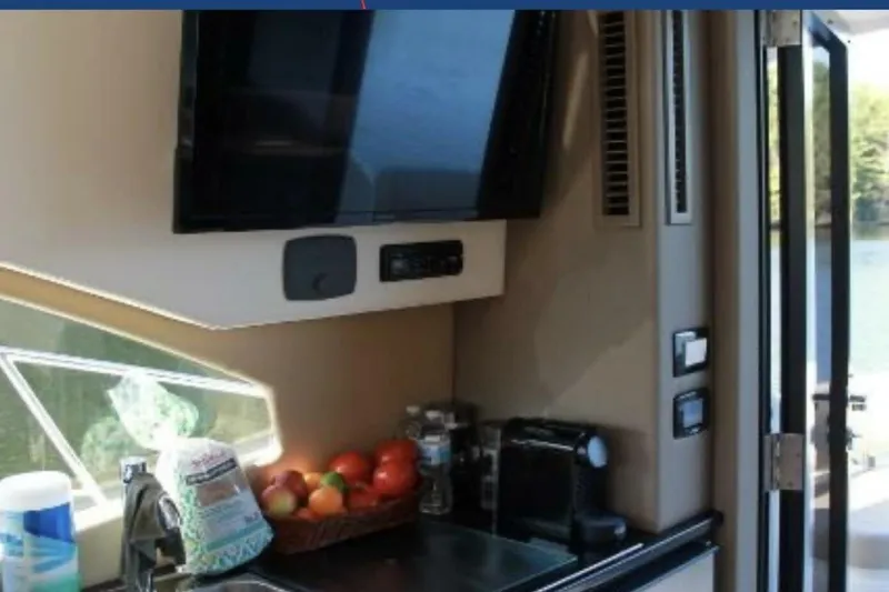  Yacht Photos Pics Interior of 2017 Carver C37 yacht with TV, fruit basket, and coffee maker.